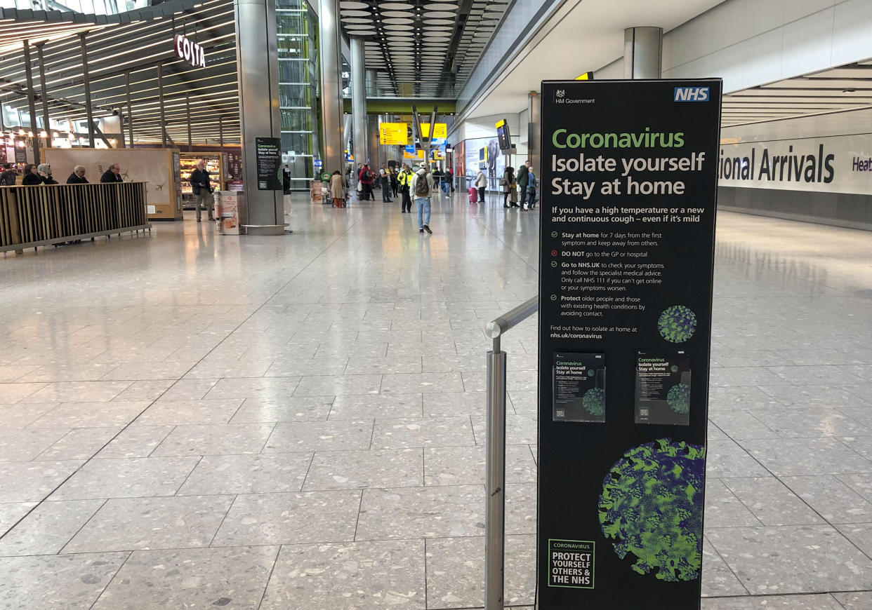 A sign in the empty arrivals area of Terminal 5 of Heathrow Airport telling passengers what to do with Coronavirus as Britons have been advised against non-essential travel to anywhere in the world as the coronavirus crisis closed borders around the globe. (Photo by Steve Parsons/PA Images via Getty Images)