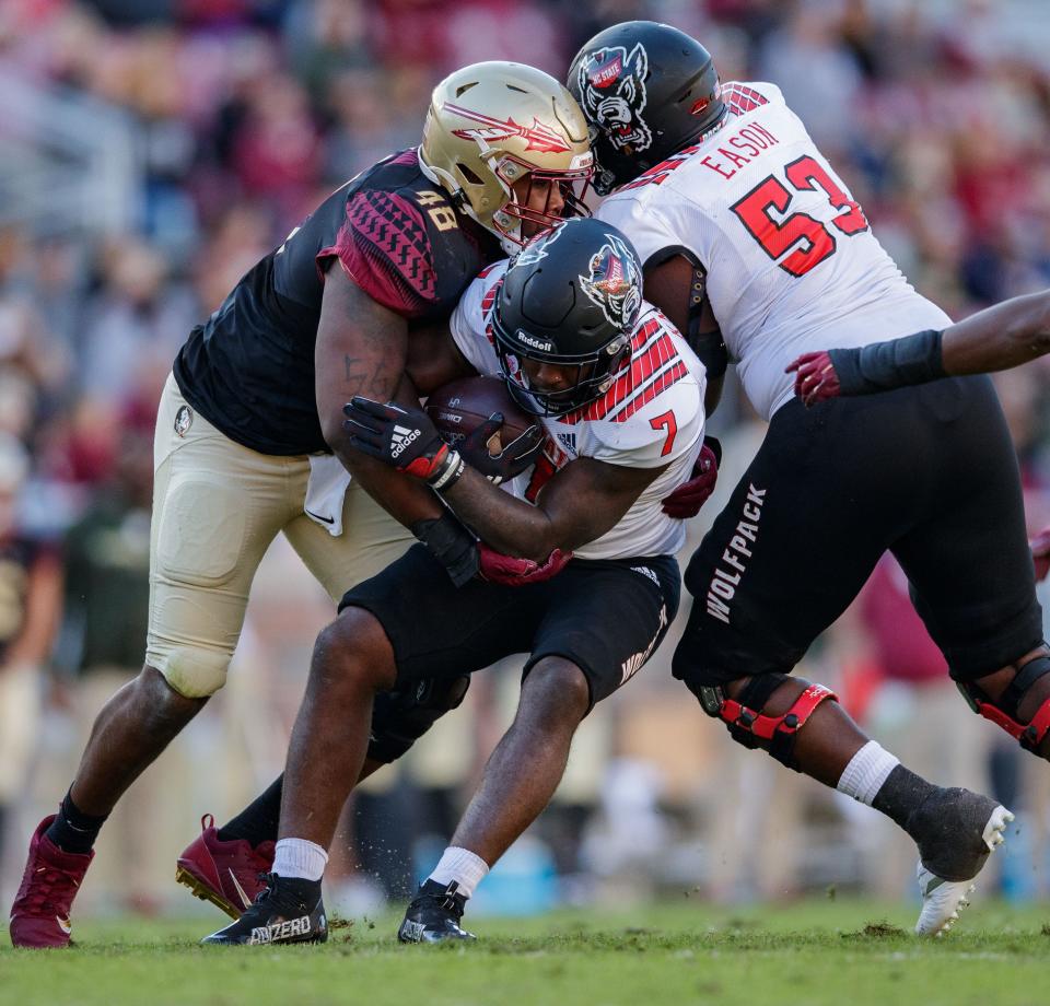 Florida State Seminoles defensive tackle Jarrett Jackson (48) tackles North Carolina State Wolfpack running back Zonovan Knight (7). The North Carolina State Wolfpack lead the Florida State Seminoles 14-0 at the half Saturday, Nov. 6, 2021.