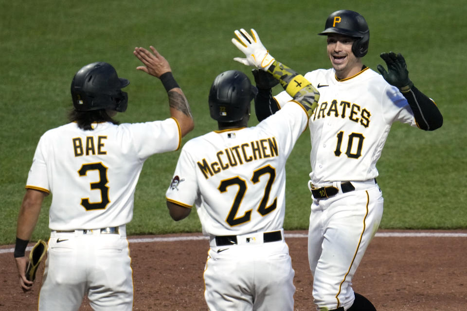 Pittsburgh Pirates' Bryan Reynolds (10) celebrates with Andrew McCutchen (22) and Ji Hwan Bae (3) after hitting a three-run home run off Arizona Diamondbacks pitcher Anthony Misiewicz during the fifth inning of a baseball game in Pittsburgh, Friday, May 19, 2023. (AP Photo/Gene J. Puskar)