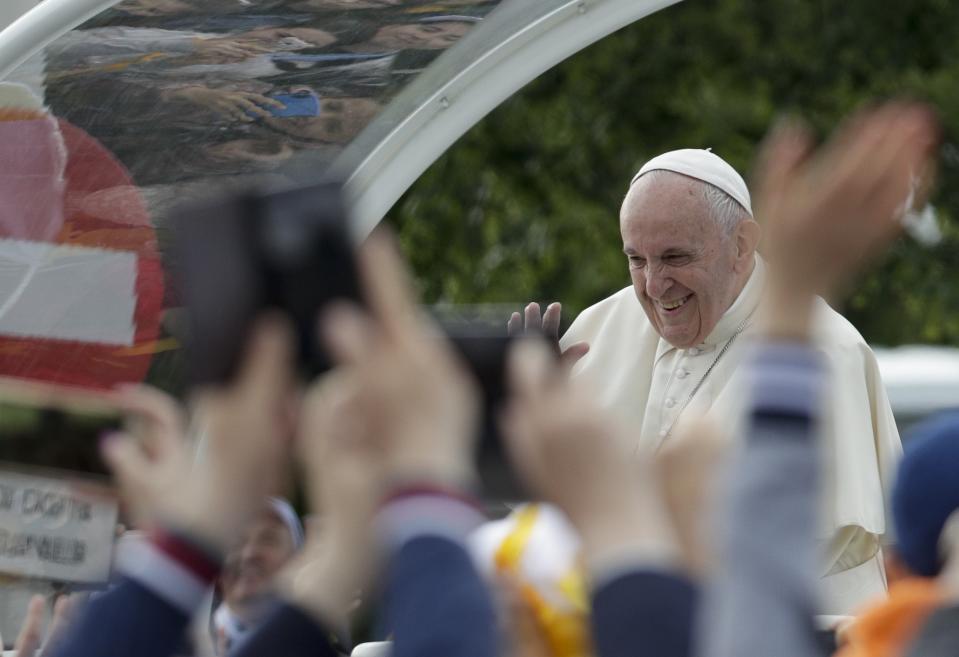 Pope Francis waves to the crowd as he arrives for a meeting with young people and families, in Iasi, Romania, Saturday, June 1, 2019. Francis began a three-day pilgrimage to Romania on Friday that in many ways is completing the 1999 trip by St. John Paul II that marked the first-ever papal visit to a majority Orthodox country. (AP Photo/Andrew Medichini)