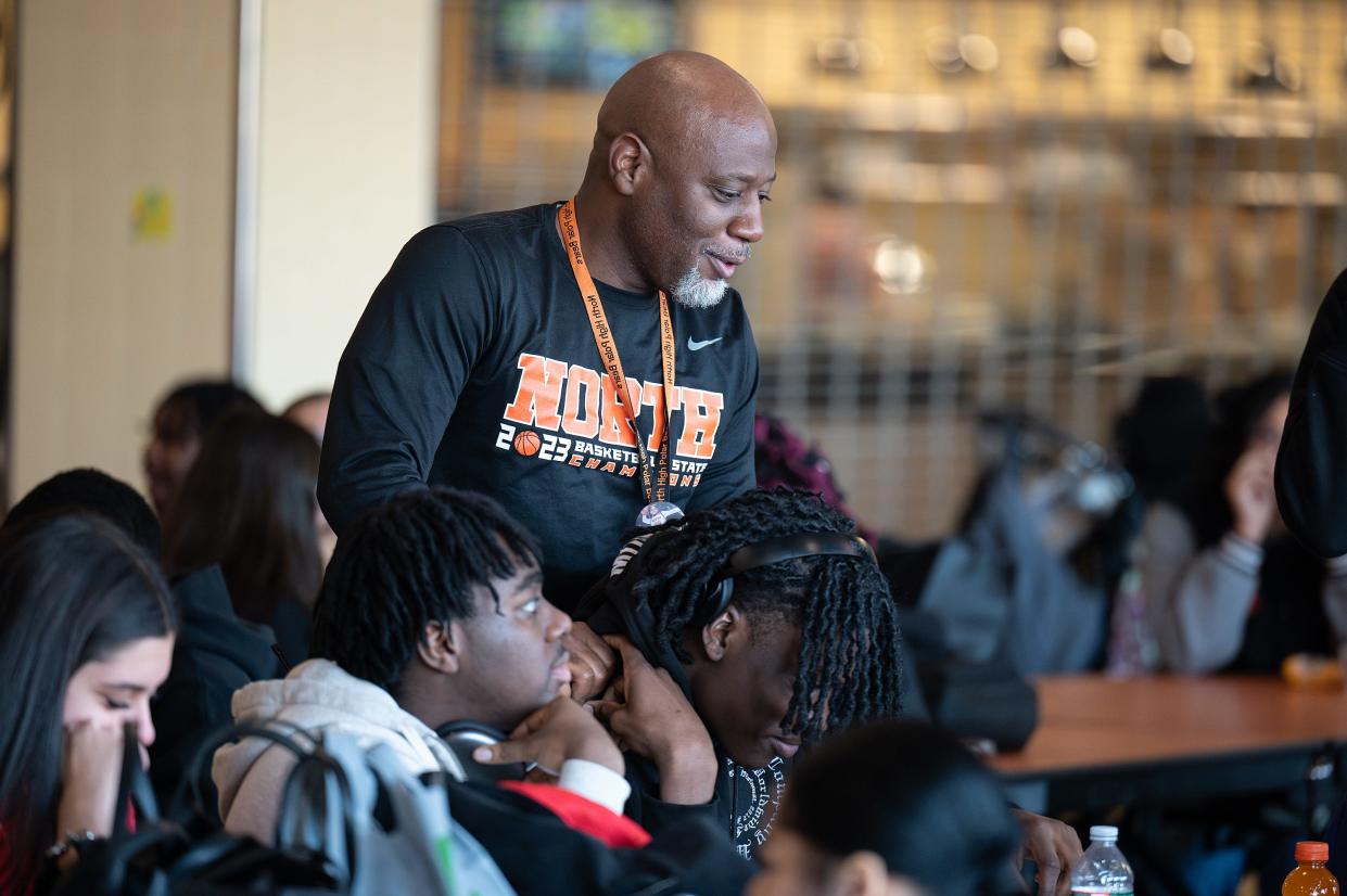 North High coach Al Pettway jokes around with senior captain Teshaun Steele during lunch on Tuesday February 27, 2024.