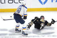 Boston Bruins left wing Brad Marchand, right, is dropped to the ice by St. Louis Blues center Brayden Schenn (10) during the first period of an NHL hockey game, Monday, March 11, 2024, in Boston. (AP Photo/Charles Krupa)