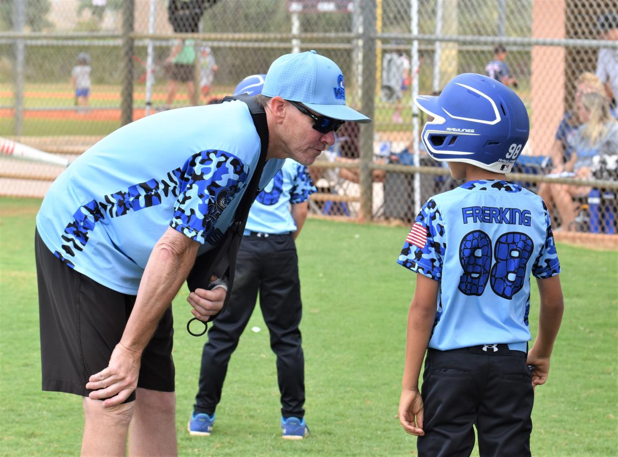 The West Boynton Travel league's Cobras head coach Jerry Parker gives some hitting advice to Noah Frerking on April 28, 2024.