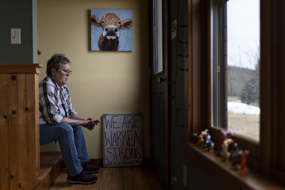 Kathy Miller looks at her wedding ring while sitting for a portrait at her home Monday, March 4, 2024, in Elmore, Vt. Miller owned the Elmore Store, what she considers the heartbeat of the town, for nearly four decades but sold it after her husband, Warren, died a few years ago. (AP Photo/David Goldman)