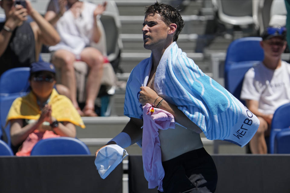 Dominic Thiem of Austria returns to the court after a break in his first round match against Andrey Rublev of Russia at the Australian Open tennis championship in Melbourne, Australia, Tuesday, Jan. 17, 2023. (AP Photo/Ng Han Guan)