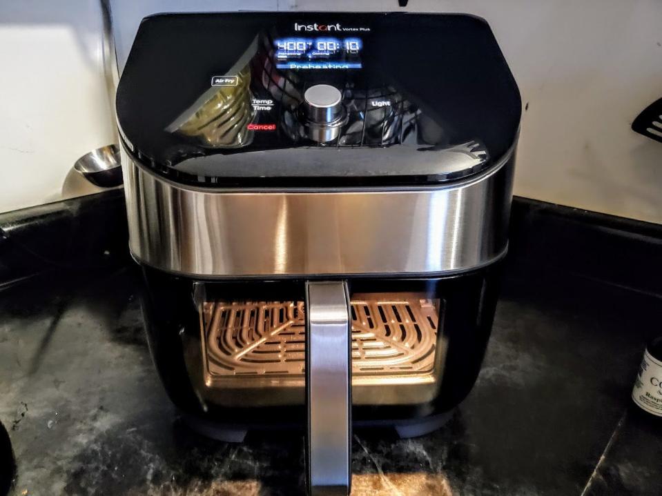 The Instant Vortex Plus Air Fryer Oven with ClearCook, the best air fryer in 2023, is displayed on a kitchen counter.