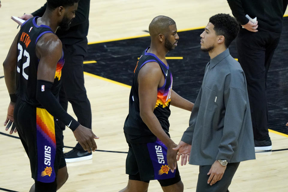 Devin Booker greets Phoenix Suns guard Chris Paul during the Phoenix Suns vs. New Orleans Pelicans game in Phoenix on April 26, 2022. - Credit: Matt York/AP