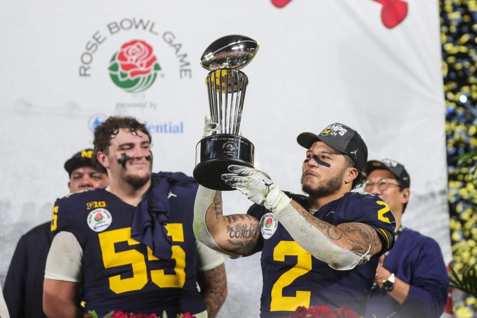 Michigan running back Blake Corum lifts the Rose Bowl trophy after the 27-20 overtime win in the Rose Bowl over Alabama at Rose Bowl Stadium in Pasadena, California, on Monday, Jan. 1, 2024.