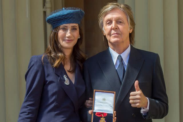 <p>Bradley Page - WPA Pool/Getty</p> Paul McCartney and wife Nancy Shevell pose for a photo at Buckingham Palace in May 2018.