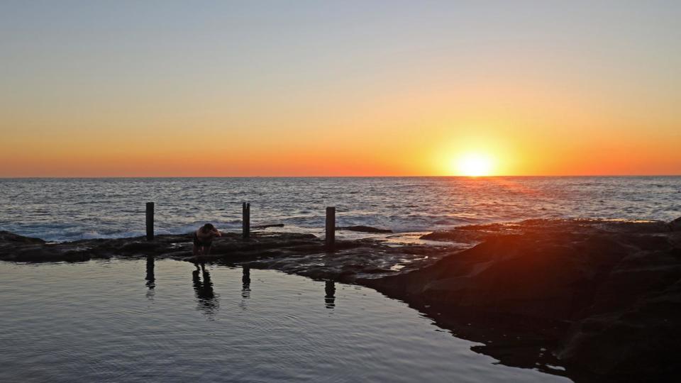 SYDNEY, AUSTRALIA - NewsWire Photos FEBRUARY 11, 2022: Sunrise is pictured over Ivor Rowe Rockpool in Sydney's eastern suburbs with temperatures set to soar. Picture: NCA NewsWire / Nicholas Eagar