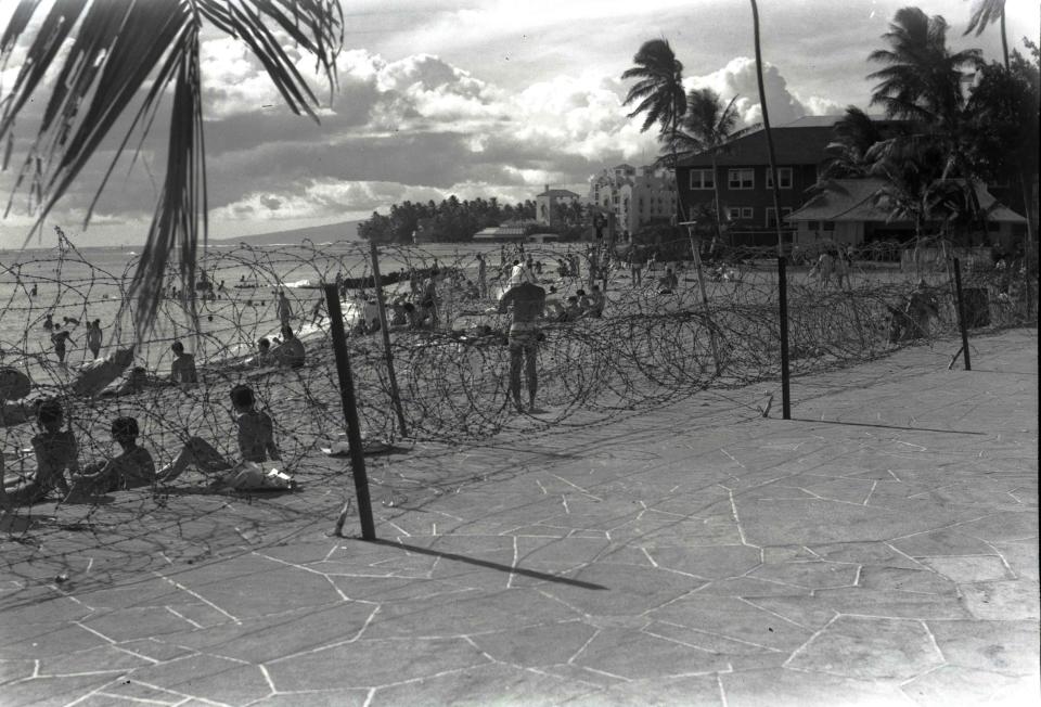 Barbed wire was installed at Waikiki Beach and other coastlines across Hawaii after the 1941 attacks on Pearl Harbor. (Photo: Bishop Museum/DeSoto Brown)