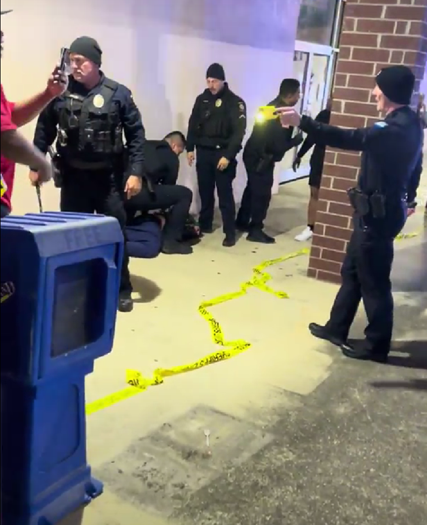 Hendersonville Police Department officer seen pointing a taser at a man at the crime scene of Elijah Timmons III's shooting.