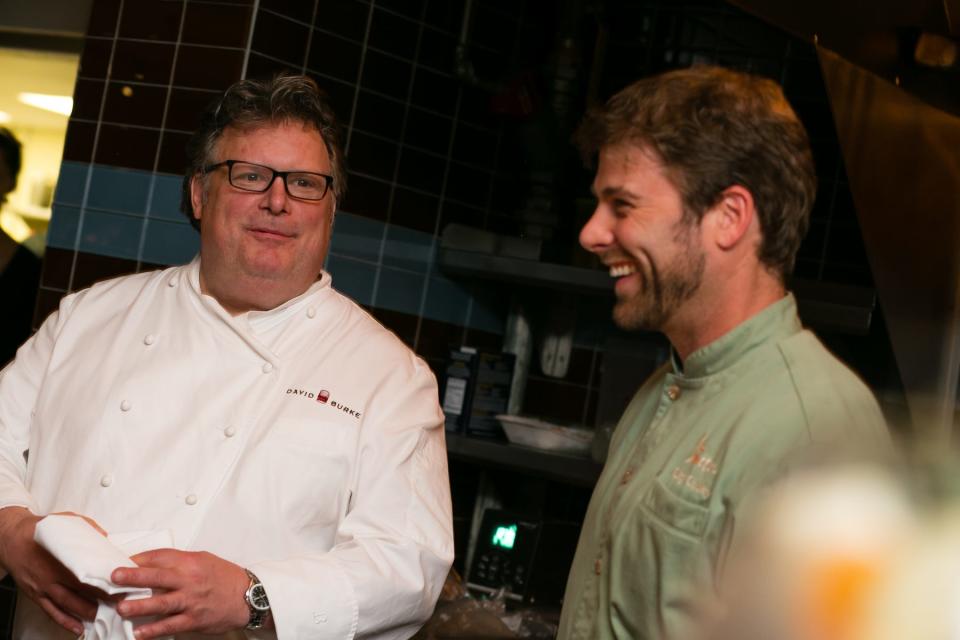 Chefs David Burke (left) and Clay Conley share a laugh at Conley's Buccan bistro during the 2014 Palm Beach Food and Wine Festival.
