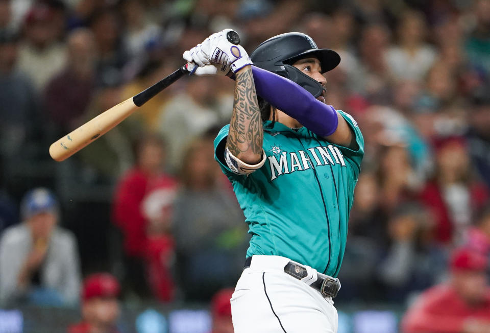 Seattle Mariners' J.P. Crawford follows through on a three-run double against the Los Angeles Angels during the fourth inning of a baseball game Tuesday, Sept. 12, 2023, in Seattle. (AP Photo/Lindsey Wasson)