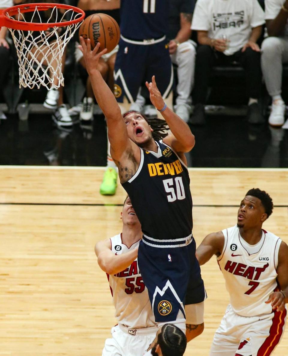 Denver Nuggets forward Aaron Gordon (50) drives to the basket over Miami Heat forward Duncan Robinson (55) and Miami Heat guard Kyle Lowry (7) in the second half of Game 4 of the NBA Finals at the Kaseya Center in downtown Miami, Fla. on Friday, June 9, 2023.