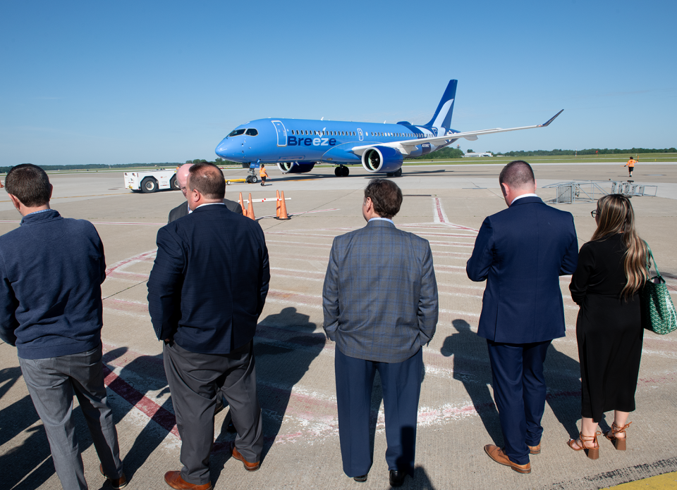 Guests watch the Breeze Airways direct flight to Los Angeles from the Akron-Canton Airport in Green on Thursday.