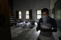 A person tries to identifies the body of his relative who was traveling in the train that derailed in a school, in Balasore district, in the eastern Indian state of Orissa, Sunday, June 4, 2023. Indian authorities end rescue work and begin clearing mangled wreckage of two passenger trains that derailed in eastern India, killing over 300 people and injuring hundreds in one of the country’s deadliest rail crashes in decades. (AP Photo/Rafiq Maqbool)