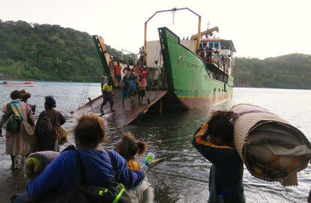 Residents carrying their possessions board a boat at Lolowai Port as they evacuate due to the Manaro Voui volcano continuing to emenate smoke and ash on Vanuatu's northern island of Ambae in the South Pacific, October 1, 2017. REUTERS/Ben Bohane