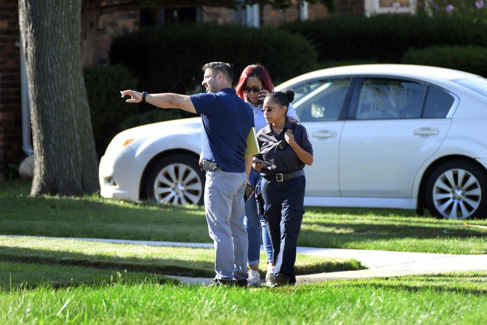 Detroit Police and investigators look over a shooting scene on Pennington Drive, north of Seven Mile Road, Sunday, Aug. 28, 2022, in Detroit. Four people were shot, with fatalities, by a person who appeared to be firing at people randomly over a roughly 2 1/2-hour period Sunday morning in Detroit, police said. (Jose Juarez/Special to Detroit News via AP)