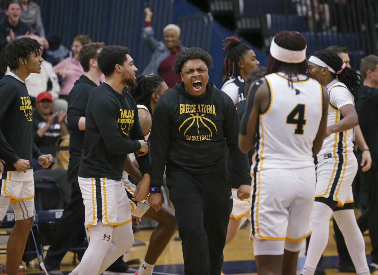 The Athena bench erupts in celebration after the Trojans took the lead in the fourth quarter forcing Penfield into calling a time out.