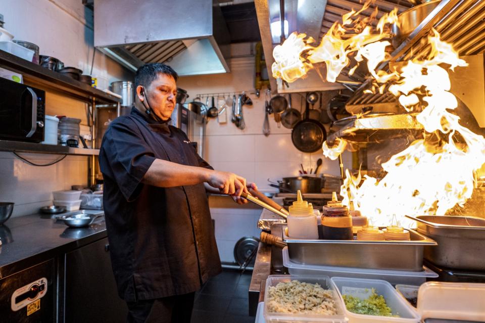 A chef prepares food at the Jekyll & Hyde restaurant in Singapore. Photographer: Edwin Koo/Bloomberg