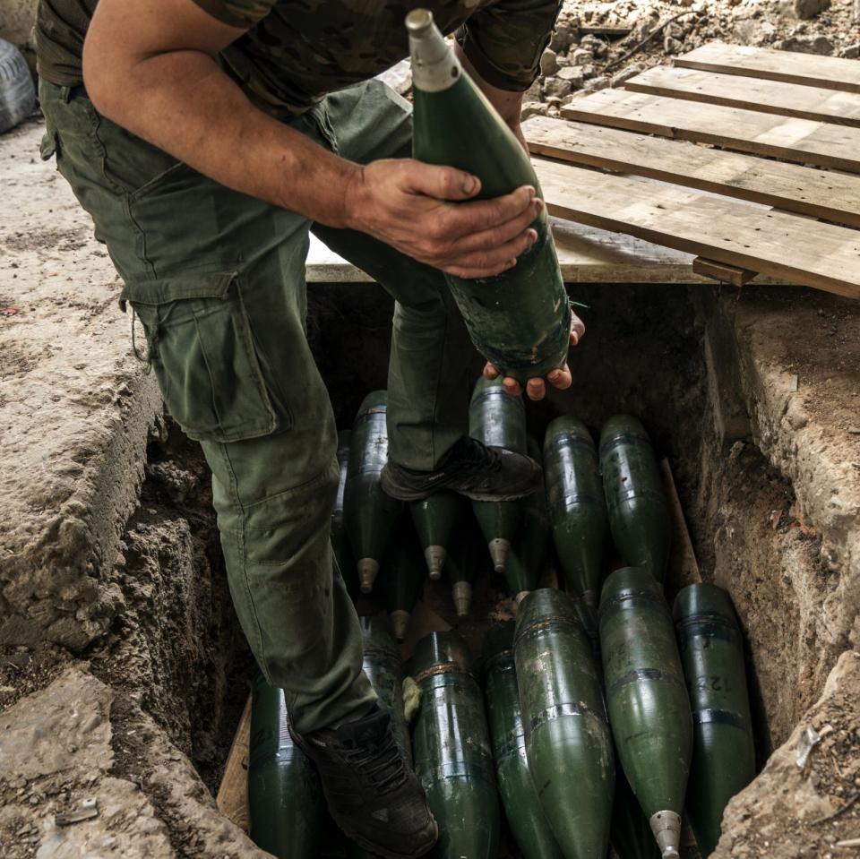 A Ukrainian soldier prepares artillery shells at their fighting position near Chasiv Yar in Donetsk Oblast in Ukraine, on June 9