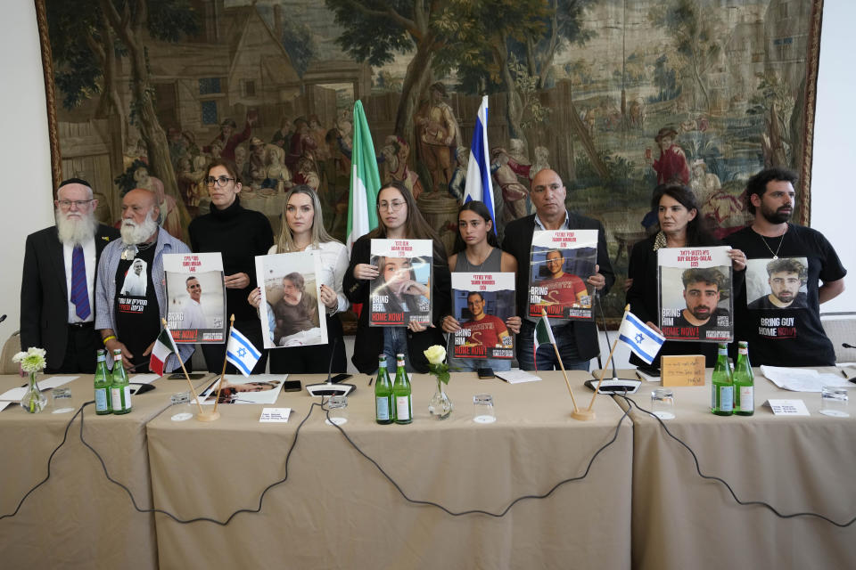 Relatives of Israeli hostages being held by Hamas, from left, Bezalel Schneider, Dani Miran, Naama Miran, Ashley Waxman Bakshi, Li-Yam Berger, Amit Nimrodi, Alon Nimrodi Meirav Gilboa-Dalal, and Gal Gilboa-Dalal, pose with photos of the kidnapped before a press conference in Rome, Monday, April 8, 2024. Pope Francis met Monday with relatives of hostages taken by Hamas on Oct. 7, marking the six-month anniversary of the attack in southern Israel with an hourlong audience. (AP Photo/Alessandra Tarantino)