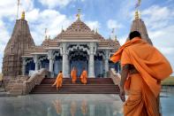 Hindu monks arrive at the first stone-built Hindu temple in Abu Mureikha, 40 kms, 25 miles, northeast of Abu Dhabi, United Arab Emirates, Monday, Feb. 12, 2024. The soon-to-open BAPS Hindu Mandir signals just how far the United Arab Emirates has come in acknowledging the different faiths of its expatriate community, long dominated by Indians who power life across its construction sites and boardrooms. (AP Photo/Kamran Jebreili)