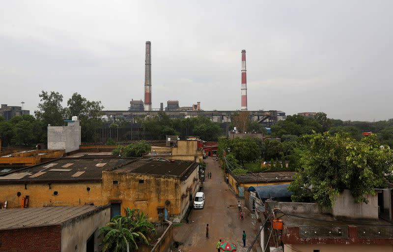 FILE PHOTO: Chimneys of a coal-fired power plant are pictured in New Delhi, India
