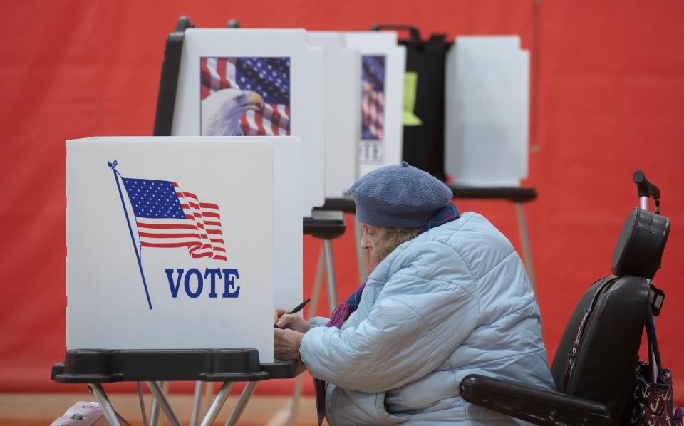 Janice Staicar puts pen to ballot as she casts her vote at the Hyannis Youth and Community Center where three town of Barnstable precincts voted in Tuesday's primary.