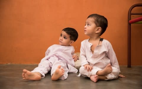 Two boys sit on a clinc floor - Credit:  Insiya Syed