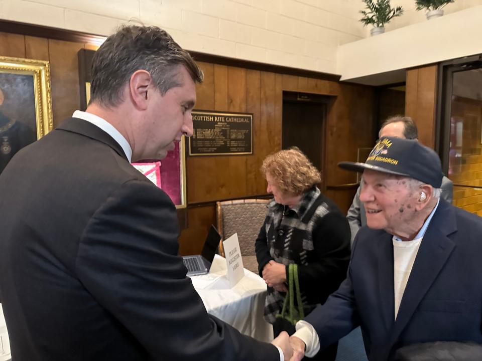 U.S. Rep. Seth Magaziner greets 100-year-old Dewey Turilli of Warwick, who was a P-51 Mustang ground crew member on Iwo Jima in 1945. Magaziner gave welcoming remarks at the Rhode Island Aviation Hall of Fame's annual dinner and award ceremony on Nov. 18.