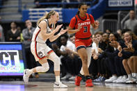 UConn guard Paige Bueckers reacts toward Dayton guard Anyssa Jones (3) in the first half of an NCAA college basketball game, Wednesday, Nov. 8, 2023, in Storrs, Conn. (AP Photo/Jessica Hill)
