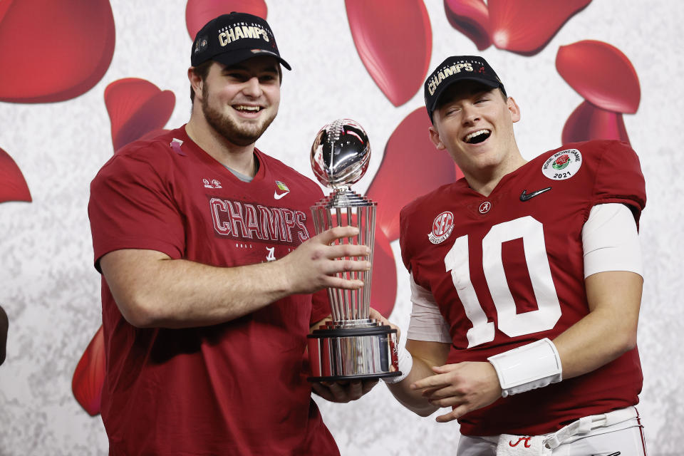 Landon Dickerson and Mac Jones (10) of the Alabama Crimson Tide pose with the Leishman Trophy after defeating Notre Dame in the Rose Bowl at AT&T Stadium on Jan. 1. (Tom Pennington/Getty Images)