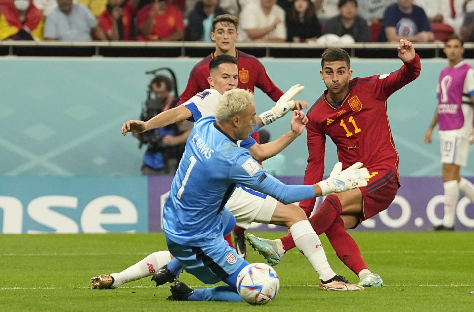 Spain's Ferran Torres, right, scores his side's fourth goal during the World Cup group E soccer match between Spain and Costa Rica, at the Al Thumama Stadium in Doha, Qatar, Wednesday, Nov. 23, 2022. (AP Photo/Pavel Golovkin)