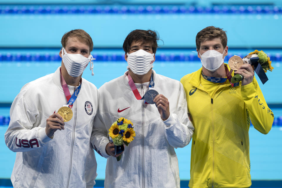 Chase Kalisz, Jay Litherland and Brendon Smith pose with their medals wearing masks after the men's 400m individual medley final during the Tokyo 2020 Olympic Games.