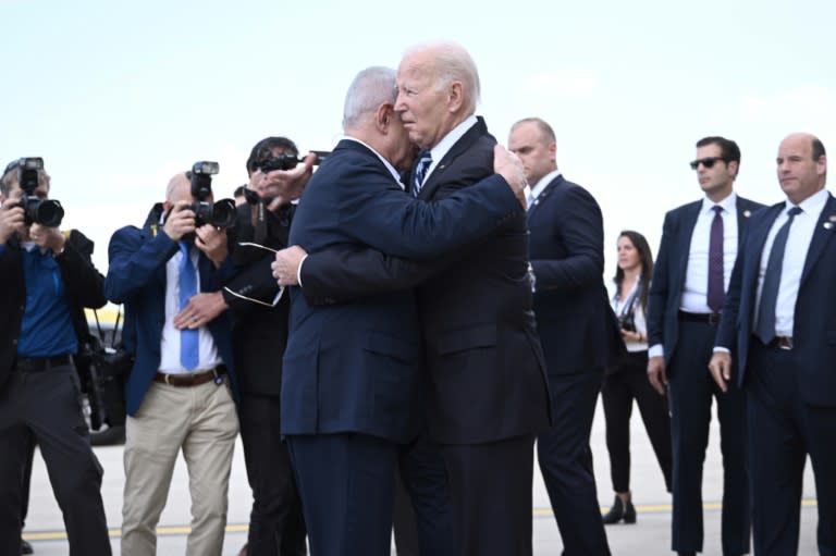 Israel Prime Minister Benjamin Netanyahu hugs US President Joe Biden upon his arrival at Tel Aviv's Ben Gurion airport on October 18, 2023 (Brendan SMIALOWSKI)