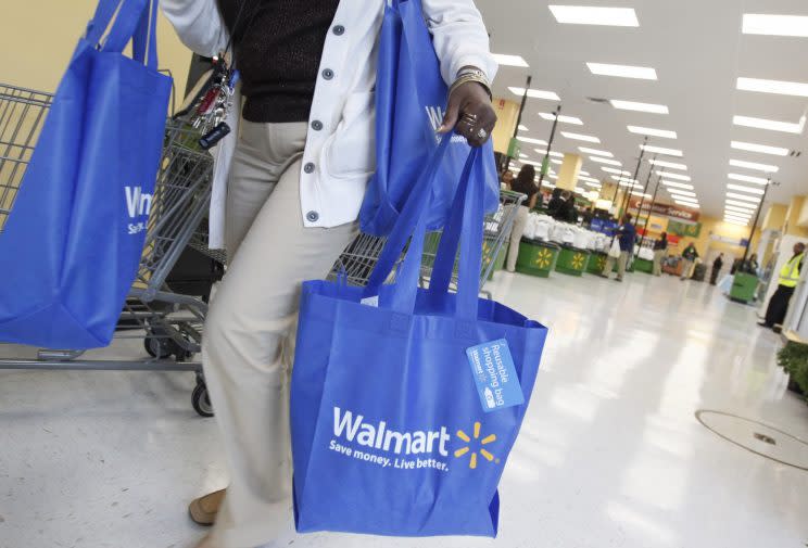 A shopper carries her purchases from a newly opened Walmart Neighborhood Market in Chicago. (Reuters/Jim Young)