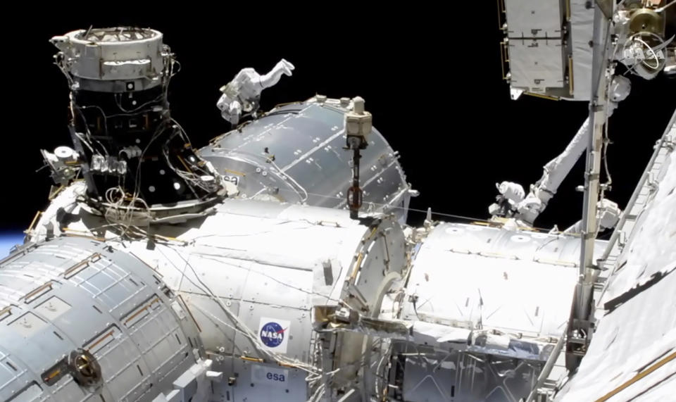 In this image taken from NASA video, NASA astronaut Mike Hopkins works outside the International Space Station’s European lab on Wednesday, Jan. 27, 2021. Hopkins and Victor Glover went spacewalking Wednesday to install a high-speed data link outside the International Space Station’s European lab and connect cables for an experiment platform awaiting activation for almost a year. (NASA via AP)