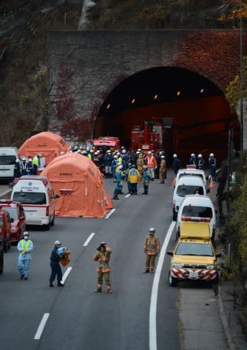 Japanese rescue workers and police gather outside the Sasago tunnel along the Chuo highway near Otsuki city after part of the tunnel collapsed. Japanese rescuers found five charred bodies and a trucker was pronounced dead after being pulled from his vehicle following the collapse