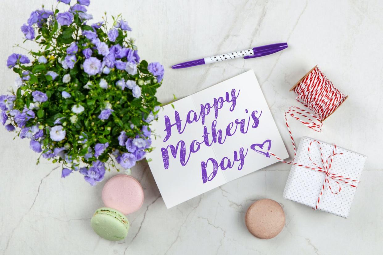 Happy mother's day care with flowers and macaroons