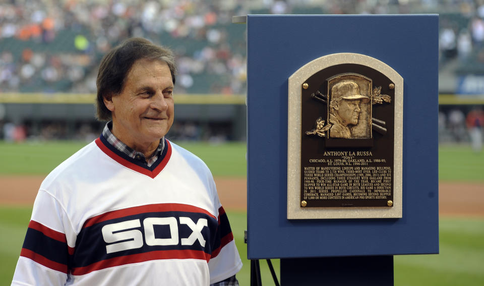 FILE - In this Aug. 30, 2014, file photo, former Chicago White Sox manager Tony La Russa stands with his Baseball Hall of Fame plaque before the second baseball game of a doubleheader against the Detroit Tigers in Chicago. La Russa, the Hall of Famer who won a World Series championship with the Oakland Athletics and two more with the St. Louis Cardinals, is returning to manage the Chicago White Sox 34 years after they fired him, the team announced Thursday, Oct. 29, 2020. (AP Photo/Matt Marton, File)