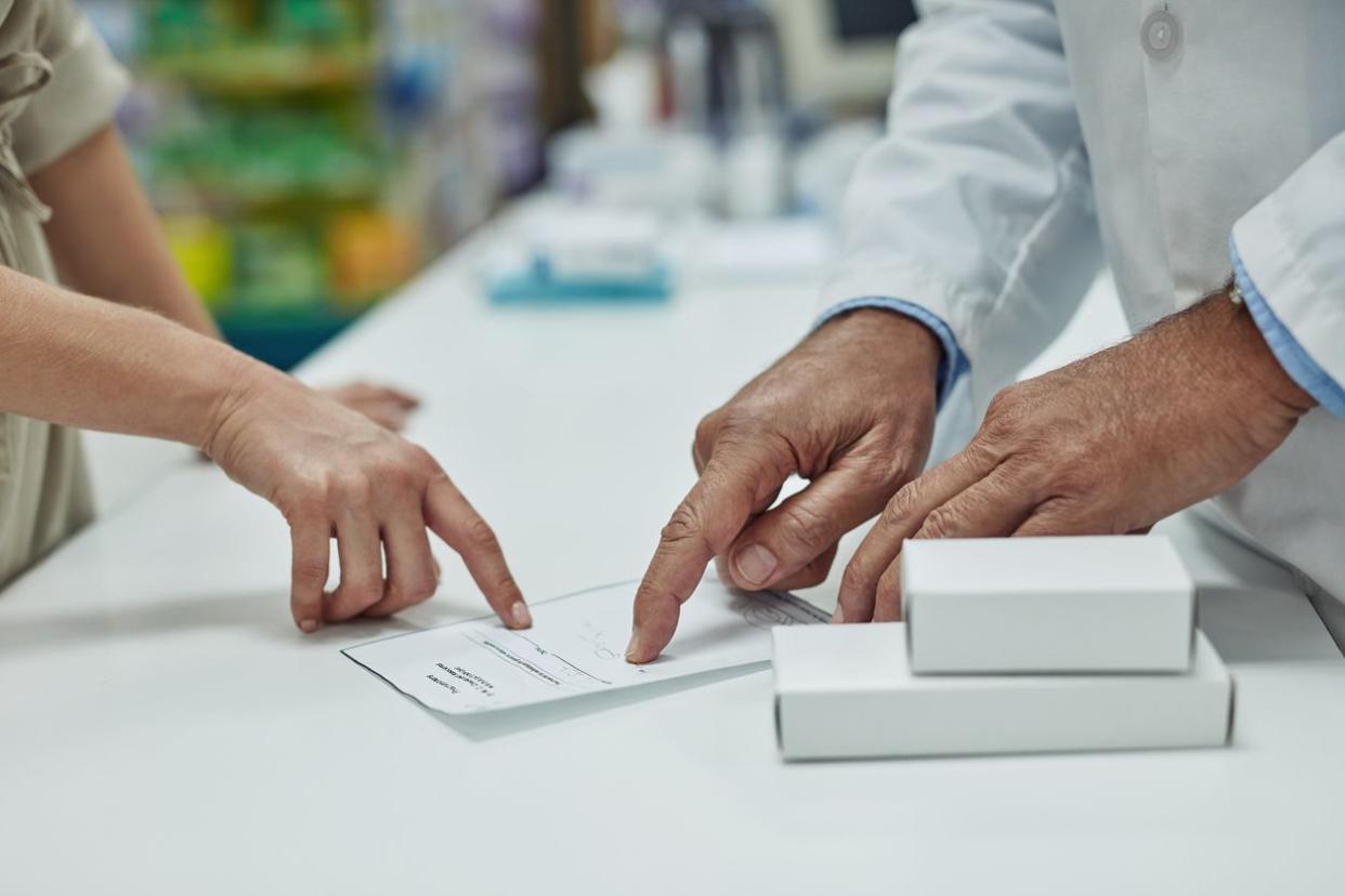 Cropped shot of a customer getting her prescription filled at a chemist