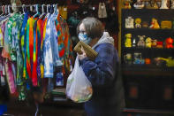 A patron at the Harmony Emporium makes her way past the tie-dye shorts after making a purchase on Saturday, Nov. 28, 2020, in Harmony, Pa. Many smaller businesses hope to see a boost on the Saturday following Thanksgiving, traditionally known as Small Business Saturday. (AP Photo/Keith Srakocic)