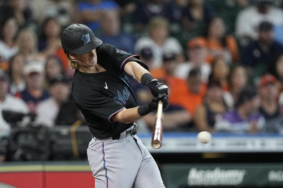 Miami Marlins' Luke Williams hits a RBI-single against the Houston Astros during the second inning of a baseball game Saturday, June 11, 2022, in Houston. (AP Photo/David J. Phillip)