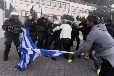 Greek farmers scuffle with riot police officers during a demonstration against planned pension reforms in the northern city of Thessaloniki, Greece, January 28, 2016. REUTERS/Alexandros Avramidis