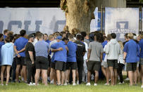 Indiana State football assistant head coach Mark Smith hugs a player after a vigil on Sunday, Aug. 21, 2022 at Memorial Stadium in Terre Haute, Ind., for students, including fellow football players, who were involved in a car crash earlier in the day. (Joseph C. Garza/The Tribune-Star via AP)