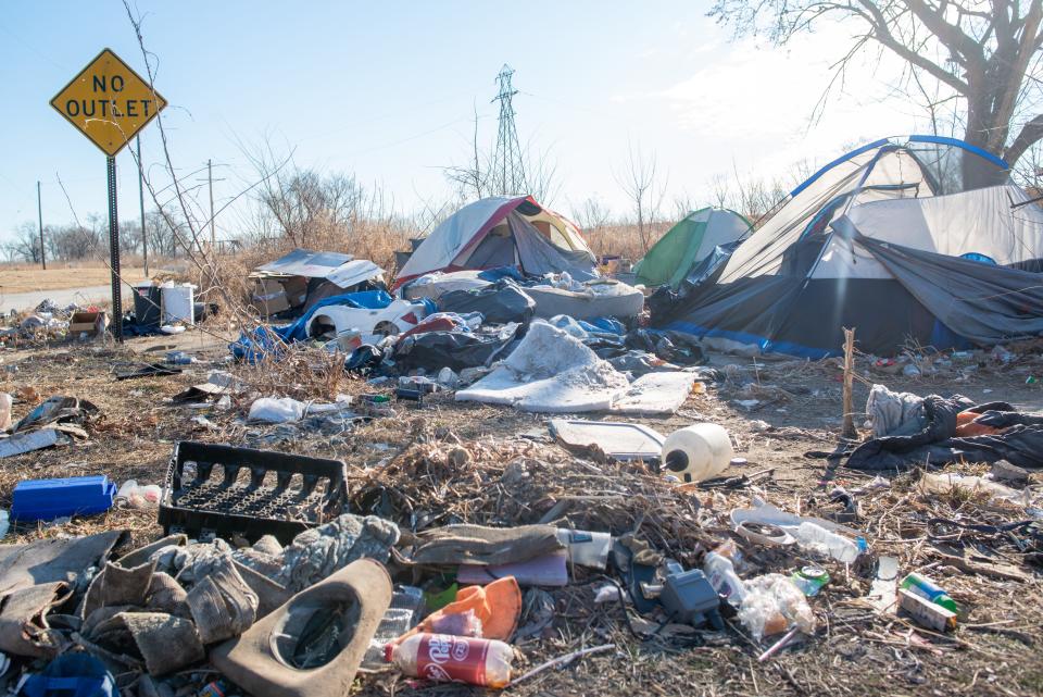 Multiple tents are seen north of the Kansas River in a small community for the homeless.