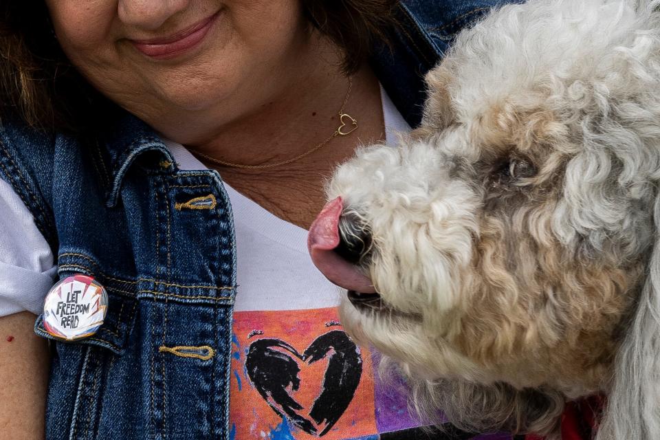 Diana Haneski, a school librarian, bonds with her pet River, a therapy dog for Marjory Stoneman Douglas High School, in her free time on Feb. 10, 2024, in Parkland, Florida.
