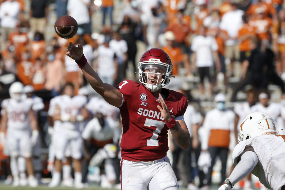 Oklahoma quarterback Spencer Rattler (7) throws a pass on a 2-point conversion against Texas during the fourth overtime of NCAA college football game in Dallas, Saturday, Oct. 10, 2020. Oklahoma defeated Texas 53-45 in four overtimes. (AP Photo/Michael Ainsworth)